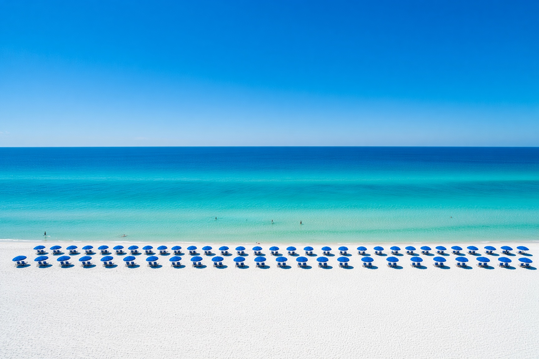 White sand and blue umbrellas on the gulf